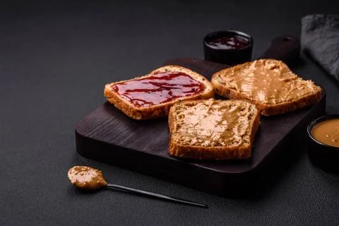 Nutritious sandwiches consisting of bread, raspberry jam and peanut butter... Stock Photos