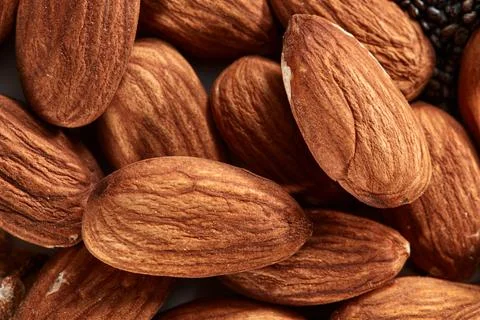 Nuts almond background, close-up view of nuts. Healthy vegan snack. Top view. Stock Photos