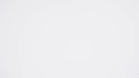 Nuts of almonds fall on a white table. Slow motion. Stock Footage 88824538