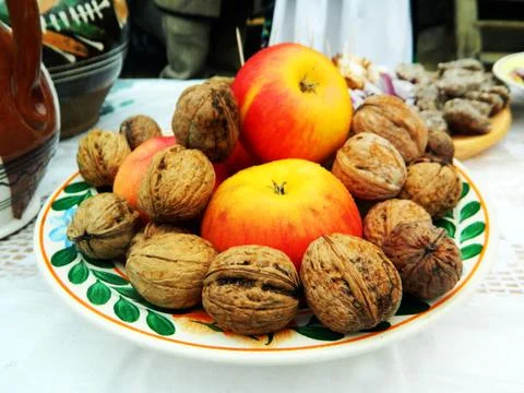 Nuts and apples in a basket Stock Photos