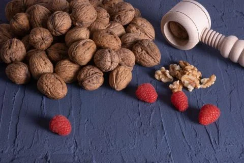 Nuts and berries scattered on a table Stock Photos