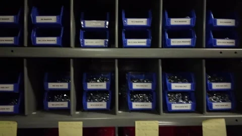 Nuts and bolts in blue storage bins on industrial shop shelves Stock Footage 341323625