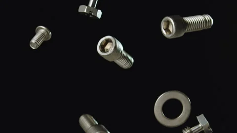 Nuts and  Bolts Falling with Black Background Slow Motion Stock Footage 159613152
