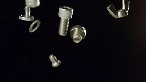 Nuts and  Bolts Falling with Black Background Slow Motion Stock Footage 159613161