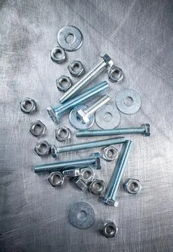 Nuts and bolts on the table. Stock Photos