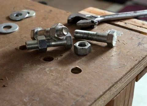Nuts and bolts on workbench Fotos de archivo