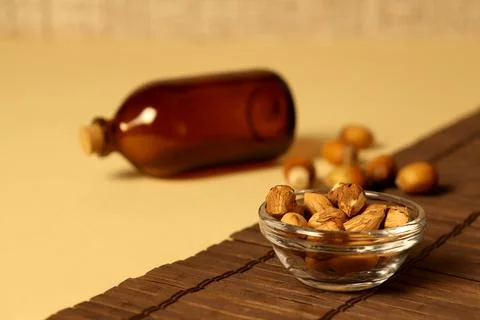 Nuts and bottle on table in kitchen setting during afternoon light in home Stock Photos