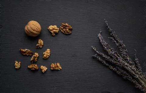 Nuts and lavender on a black background. concept: healthy lifestyle Stock Photos