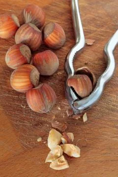 Nuts and nutcracker on a wooden cut table Foto stock
