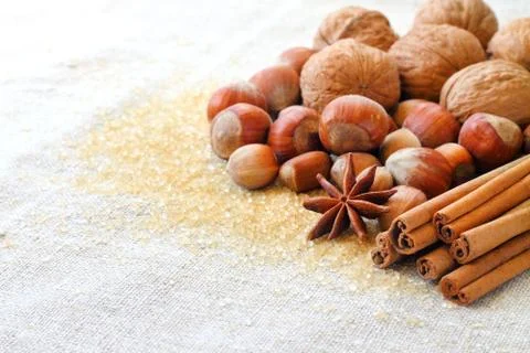 Nuts and spices on sacking background Stock Photos