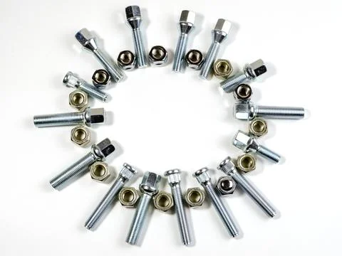 Nuts and studs for a car on a table Stock Photos