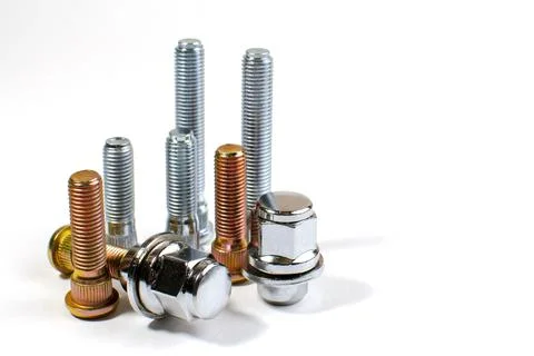 Nuts and studs for a car on a table Stock Photos