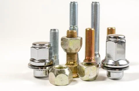 Nuts and studs for a car on a table Stock Photos