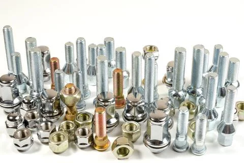Nuts and upright studs and bolts for a car on a table Foto stock