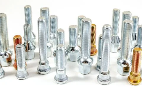 Nuts and upright studs and bolts for a car on a table Stock Photos