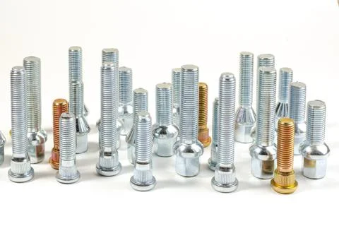 Nuts and upright studs and bolts for a car on a table Stock Photos