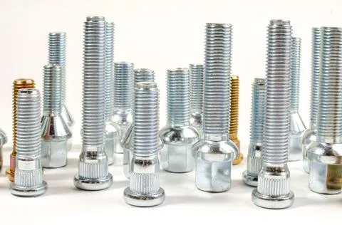 Nuts and upright studs and bolts for a car on a table Stock Photos