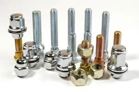 Nuts and upright studs for a car on a table Stock Photos