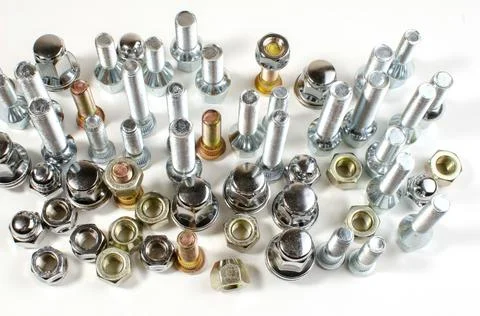 Nuts and upright studs for a car on a table Stock Photos