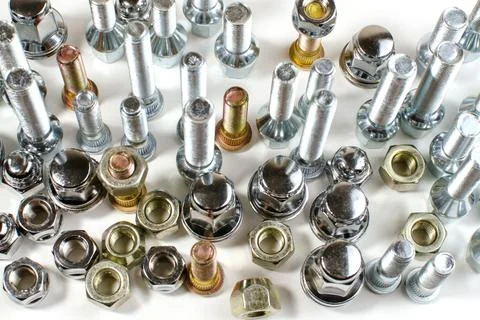 Nuts and upright studs for a car on a table Stock Photos