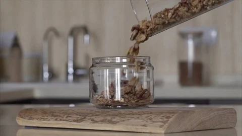 Nuts and walnuts slowly pour into a jar Stock Footage 72530918