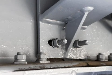 Nuts are attached to steel structures in construction. Stock Photos