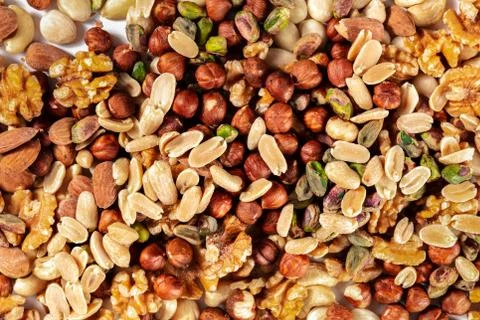 Nuts background. A mix of peanuts, hazelnuts, walnuts, pistachios and almonds Stock Photos
