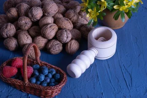 Nuts, berries, snowdrops on a table Stock Photos
