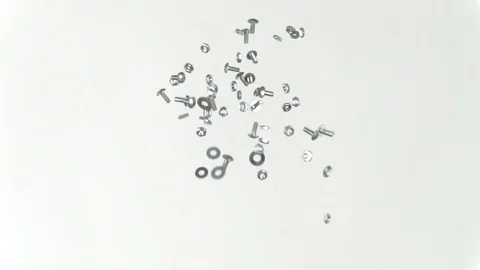 Nuts, bolts and washers being tossed in the air, slow motion, repeat Stock Footage