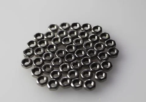 Nuts for bolts on the table Stock Photos