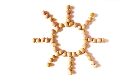Nuts create a sun shape and scatter Stock Footage 116748340