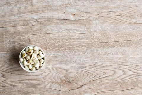 Nuts in a cup on an old wood grain table Left corner and take a closeup and.. Foto stock
