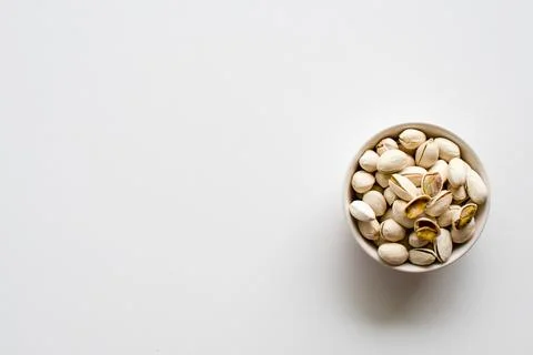 Nuts in a cup on a white background lower right corner, take a closeup and .. Stock Photos