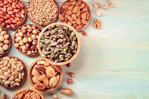 Nuts design layout with copy space. Pistachios, cashews, pine nuts etc Fotos Stock