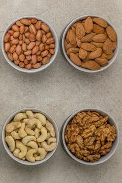 Nuts of different varieties, top view. Vertical photo for background, nuts in Stock Photos