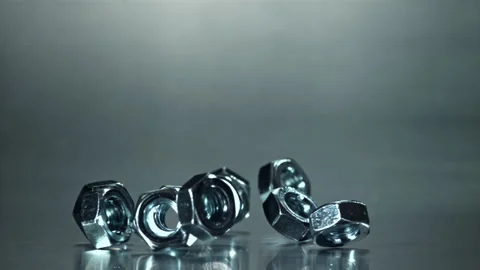 Nuts fall on a metal surface. Filmed on a high-speed camera at 1000 fps. Stock Footage 307933006