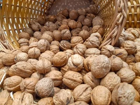 Nuts falling from a wicker basket 스톡 사진