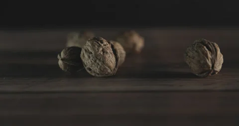 Nuts filmed in slow motion with a dark mood on a wooden background. Stock Footage 172155791