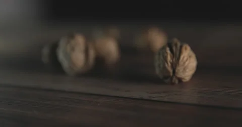 Nuts filmed in slow motion with a dark mood on a wooden background. Stock Footage 172155980