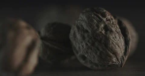 Nuts filmed in slow motion with a dark mood on a wooden background. Stock Footage 172156645