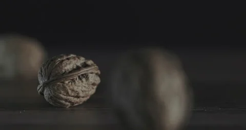 Nuts filmed in slow motion with a dark mood on a wooden background. Stock Footage 172156702