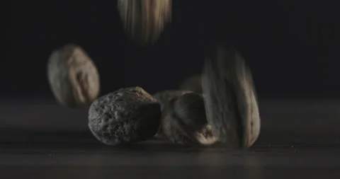Nuts filmed in slow motion with a dark mood on a wooden background. Stock Footage 172156729