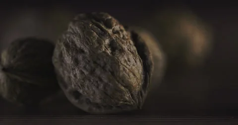 Nuts filmed in slow motion with a dark mood on a wooden background. Stock Footage 172156887