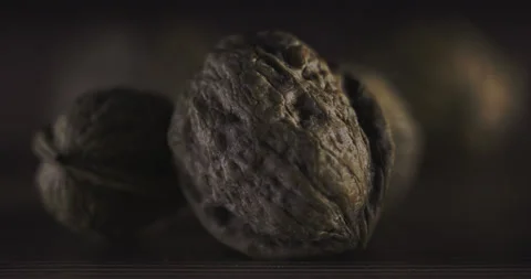 Nuts filmed in slow motion with a dark mood on a wooden background. Stock Footage 172157140