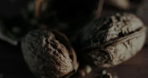 Nuts filmed in slow motion with a dark mood on a wooden background. Stock Footage 172157391