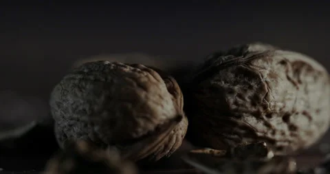 Nuts filmed in slow motion with a dark mood on a wooden background. Stock Footage 172157510