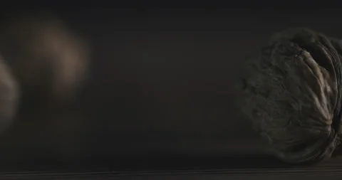 Nuts filmed in slow motion with a dark mood on a wooden background. Stock Footage 172157622