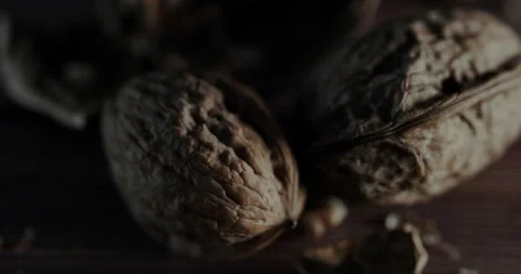 Nuts filmed in slow motion with a dark mood on a wooden background. Stock Footage 172157649