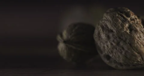 Nuts filmed in slow motion with a dark mood on a wooden background. Stock Footage 172157988