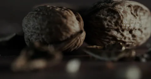 Nuts filmed in slow motion with a dark mood on a wooden background. Stock Footage 172158083